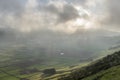 Low clouds over the Miradouro da Serra do Cume revealing the typical plots with walls landscape of Terceira Royalty Free Stock Photo