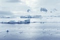 Low clouds over the mountains and chunks of ice floating of Port Lockroy research station Royalty Free Stock Photo