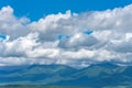 Low clouds over summer mountains green grass and blue sky Royalty Free Stock Photo