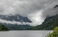Low clouds surround mountains at lake