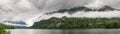 Low clouds surround mountains at lake