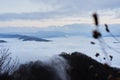 Low clouds, view of winter forest and mountains from observation deck, horizontal picture of amazing natural phenomenon. Beautiful