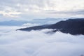 Low clouds, view of winter forest and mountains from observation deck, horizontal picture of amazing natural phenomenon. Beautiful Royalty Free Stock Photo