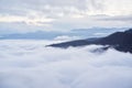 Low clouds, view of winter forest and mountains from observation deck, horizontal picture of amazing natural phenomenon. Beautiful Royalty Free Stock Photo