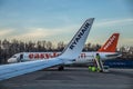 Low-cost airline RYANAIR logo on airplane`s wing and easyJet airplane at airport in Berlin