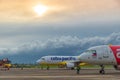 Low cost airlines Cebu Pacific and Air Asia aircraft at colorful sunset at Puerta Princesa Airport in Palawan island