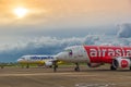 Low cost airlines Cebu Pacific and Air Asia aircraft at colorful sunset at Puerta Princesa Airport in Palawan island