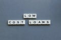 ' Low Cost Loans ' word made of square letter word on grey background