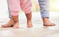 Low Cropped close up of a mixed race unrecognizable mom and little baby daughters feet stand of the floor together at Royalty Free Stock Photo