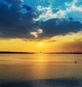 low dark dramatic clouds in sunset over river Royalty Free Stock Photo