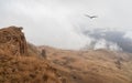Low dense clouds over a mountain valley. Beautiful panoramic view to red mountain peaks over thick clouds Royalty Free Stock Photo