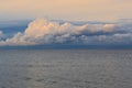 Low dramatic fluffy clouds over sea water Royalty Free Stock Photo
