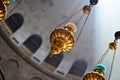 Low dutch angle shot of three hanging golden thuribles in Jerusalem, Israel