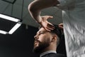 Low fade machine haircut for handsome bearded man in barbershop. Barber with dread locks making hairstyle with a smooth Royalty Free Stock Photo