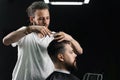 Low fade machine haircut for handsome bearded man in barbershop. Barber with dread locks making hairstyle with a smooth Royalty Free Stock Photo