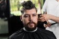 Low fade machine haircut for handsome bearded man in barbershop. Hair cut with a smooth transition. Royalty Free Stock Photo