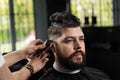 Low fade machine haircut for handsome bearded man in barbershop. Hair cut with a smooth transition. Royalty Free Stock Photo