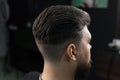 Low fade machine haircut for handsome bearded man in barbershop. Hair cut with a smooth transition. Royalty Free Stock Photo