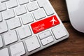 Low fare or cheap flights concept suggested by white computer keyboard with low cost tickets text on red enter key Royalty Free Stock Photo