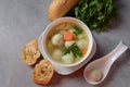 Low fat vegetable soup with chicken meatballs, potato and carrot and fresh herbs in bowl Royalty Free Stock Photo