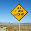 Low flying aircraft sign on side of highway.