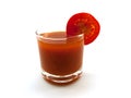 Low glass of tomato juice with a tomato segment