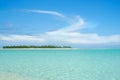 Low green island on horizon under white cloud shape Royalty Free Stock Photo