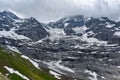 Low-hanging clouds above Eiger Gletscher and eternal snow in the Alps Royalty Free Stock Photo