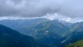 low hanging storm clouds and fog in the mountains on a summer day. blue haze in mountain valleys. it will rain Royalty Free Stock Photo