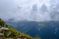 low hanging storm clouds and fog in the mountains on a summer day. blue haze in mountain valleys. it will rain Royalty Free Stock Photo