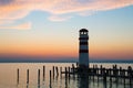 Low horizon romantic sunset sky over the lake landscape, Podersdorf Am See lighthouse