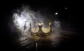 low key image of beautiful kings crown over wooden table. vintage filtered. fantasy medieval period. Selective focus Royalty Free Stock Photo