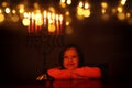 Low key image of jewish holiday Hanukkah background with cute girl looking at menorah & x28;traditional candelabra& x29; Royalty Free Stock Photo