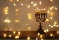 Low key image of jewish holiday Hanukkah background with menorah & x28;traditional candelabra& x29; and burning candles Royalty Free Stock Photo