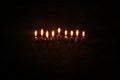 Low key image of jewish holiday Hanukkah background with menorah & x28;traditional candelabra& x29; and burning candles Royalty Free Stock Photo