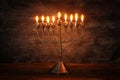 Low key image of jewish holiday Hanukkah background with menorah & x28;traditional candelabra& x29; and burning candles Royalty Free Stock Photo