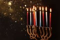 Low key Image of jewish holiday Hanukkah background with menorah & x28;traditional candelabra& x29; and burning candles. Royalty Free Stock Photo