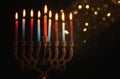 Low key Image of jewish holiday Hanukkah background with menorah & x28;traditional candelabra& x29; and burning candles. Royalty Free Stock Photo