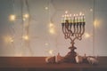 Low key image of jewish holiday Hanukkah background with traditional spinnig top, menorah & x28;traditional candelabra& x29; Royalty Free Stock Photo