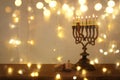 Low key image of jewish holiday Hanukkah background with traditional spinnig top, menorah & x28;traditional candelabra& x29; Royalty Free Stock Photo