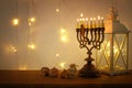 Low key image of jewish holiday Hanukkah background with traditional spinnig top, menorah & x28;traditional candelabra& x29; Royalty Free Stock Photo