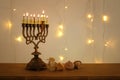 Low key image of jewish holiday Hanukkah background with traditional spinnig top, menorah & x28;traditional candelabra& x29; Royalty Free Stock Photo