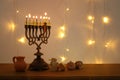 Low key image of jewish holiday Hanukkah background with traditional spinnig top, menorah & x28;traditional candelabra& x29; Royalty Free Stock Photo