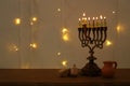 Low key image of jewish holiday Hanukkah background with traditional spinnig top, menorah & x28;traditional candelabra& x29; Royalty Free Stock Photo