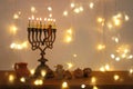 Low key image of jewish holiday Hanukkah background with traditional spinnig top, menorah & x28;traditional candelabra& x29; Royalty Free Stock Photo