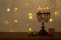 Low key image of jewish holiday Hanukkah background with traditional spinnig top, menorah & x28;traditional candelabra& x29; Royalty Free Stock Photo