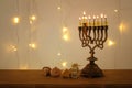 Low key image of jewish holiday Hanukkah background with traditional spinnig top, menorah & x28;traditional candelabra& x29; Royalty Free Stock Photo