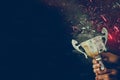 low key image of a man holding a trophy cup over dark background. Royalty Free Stock Photo