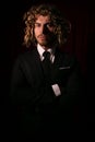 Low key lighting portrait of executive male with long hair man in a suit Royalty Free Stock Photo