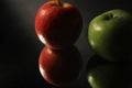 Low key lighting two reflected apples with applying rule of thirds